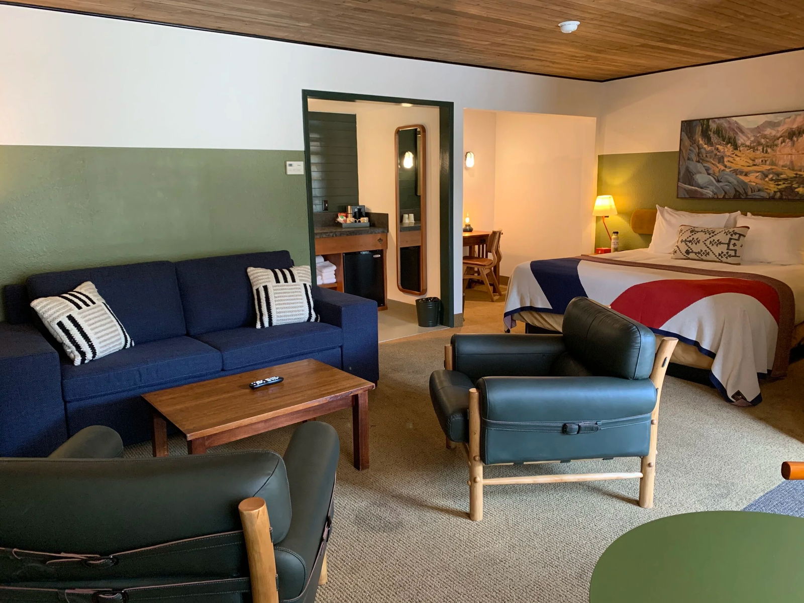 State Suite with king bed and lounge area at Station House Inn