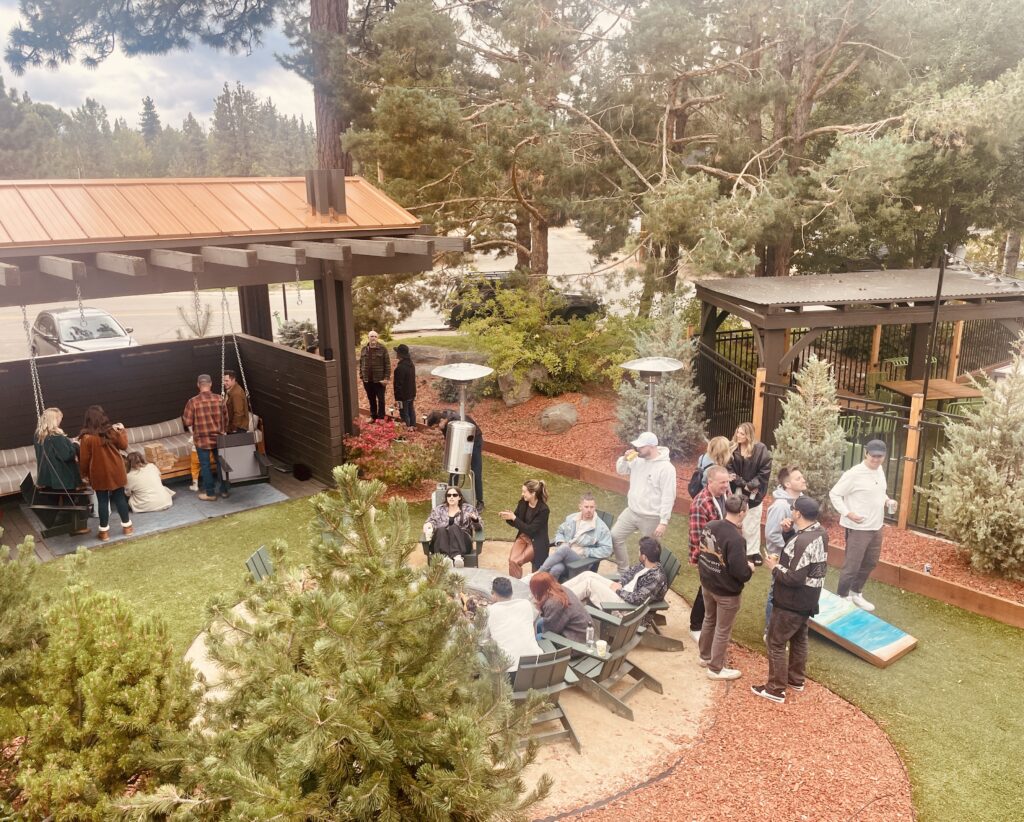 group of hotel guests hanging out by the firepits in our courtyard. part of a wedding hotel room block