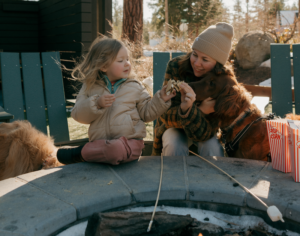 Kids making complimentary s'mores at the Station House Inn fire pit for family friendly thing to do in tahoe