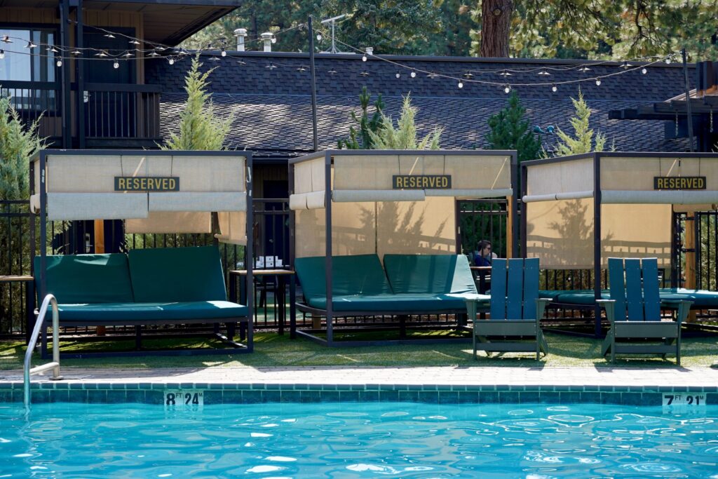 Shaded poolside cabanas at Station House Inn's heated pool, the perfect spot to unwind after a beach day