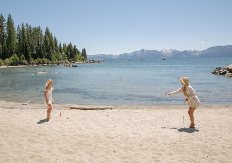 two women playing beach games on the sand in lake tahoe