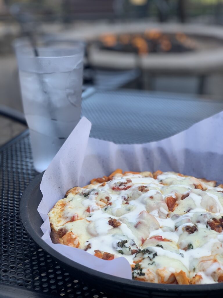 pizza at gunbarrel tavern with firepit in the background