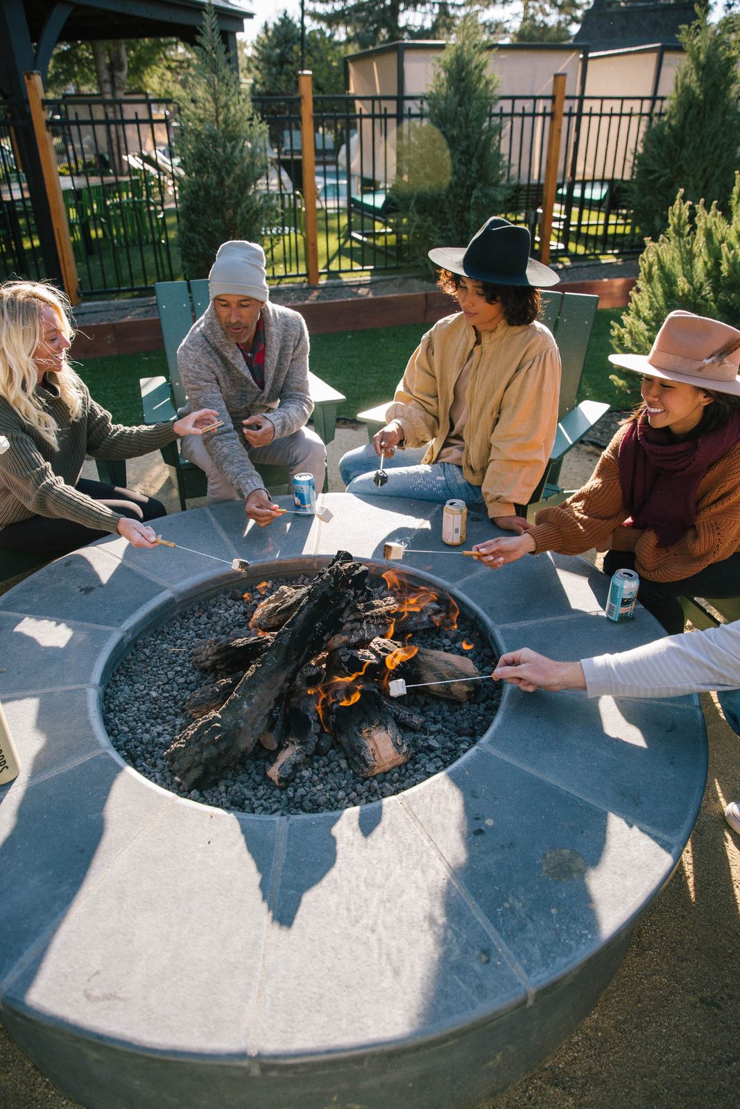Guests roasting s'mores at the Station House Inn fire pit on a crisp fall evening