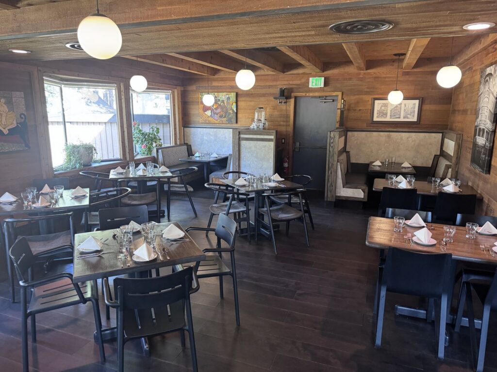 Toulouse dining room with tables and booths set for a team dinner, South Lake Tahoe